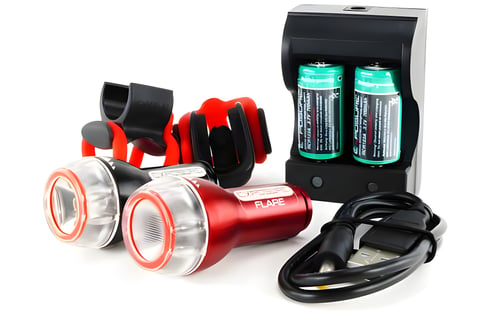 Exposure Flash and Flare bike lights with silicone mounts, USB cable and battery charger on white.