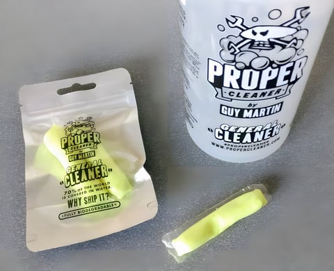 Guy Martin's Proper Cleaner bottle beside a pouch of soluble cleaner pellets and a single wrapped pellet.