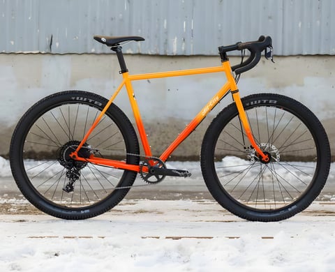All City Gorilla Monsoon monster-cross bike in orange fade paint, side view, with WTB tyres and a one-by drivetrain.