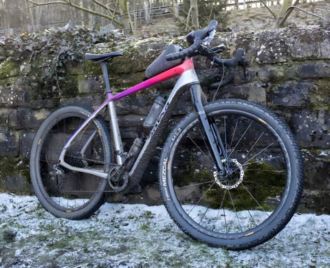 Salsa Cutthroat built for the Dirty Reiver leans on a mossy stone wall above snowy grass, Vittoria Mezcal tyres fitted.