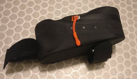 Side-zip opening of the Ortlieb Cockpit Pack, with orange zip pull and Velcro mounting straps.