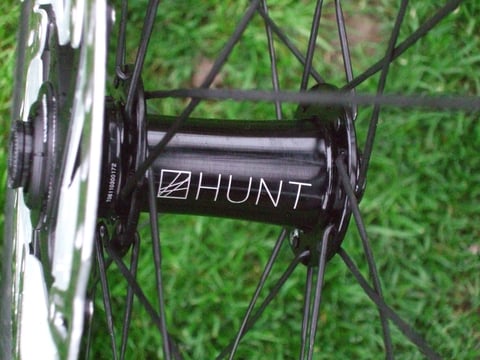 Close-up of the Hunt-branded front hub and disc rotor on the 30 Carbon Gravel wheelset.