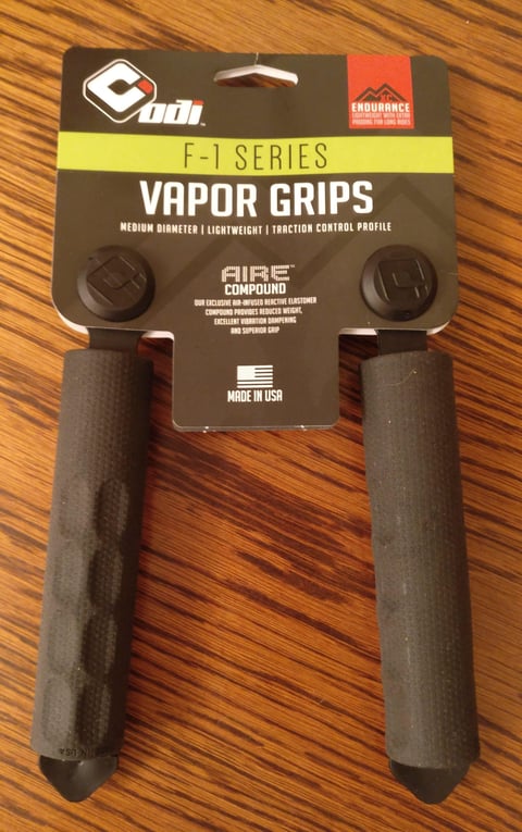 ODI F-1 Series Vapor grips in their packaging, labelled AIRE compound and Made in USA, on a wooden table.