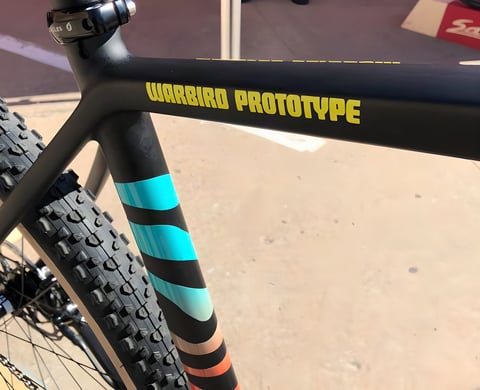 Warbird Prototype decal on the top tube of Salsa's new Warbird V4, with a striped seat tube and knobbly tyre.