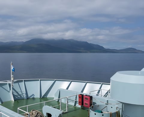 View of the Isle of Arran's hills across the water from the ferry deck, on the way to Grinduro Scotland.