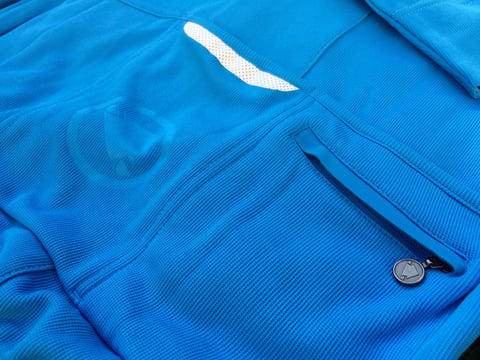 Detail of the Endura Pro SL jersey's zipped security pocket and reflective strip on the rear.