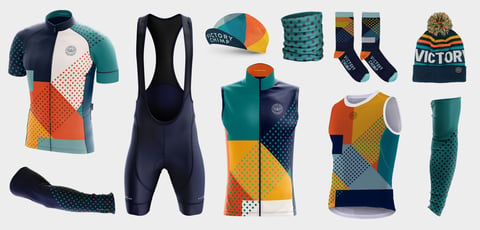 Victory Chimp Stampen Team Issue kit in navy, teal, orange and yellow: jersey, bibs, gilet, cap, socks and hat.