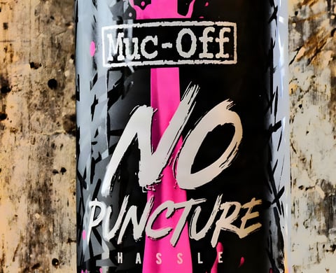 Close-up of the Muc-Off No Puncture Hassle tubeless sealant bottle label.