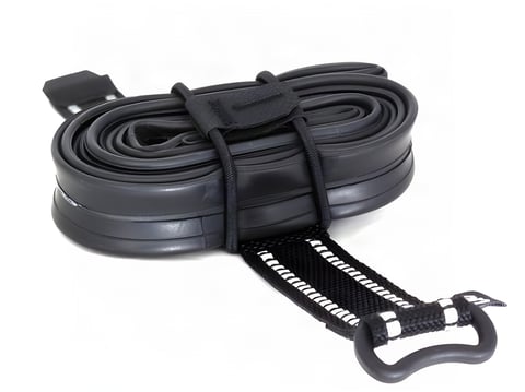 Backcountry Research Camrat strap and elastic cords wrapped round a coiled inner tube, on a white background.