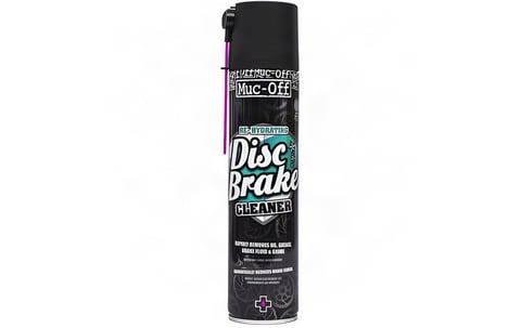 Muc-Off Disc Brake Cleaner aerosol can in black with a pink spray straw, on a white background.