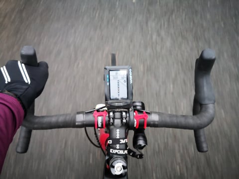 Rider's view along the Sonder Camino AL's bars at speed, with a Wahoo bike computer and front light on the stem.
