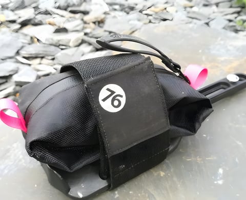 76 Projects Piggy pouch with its velcro strap on the bracket, resting on slate.