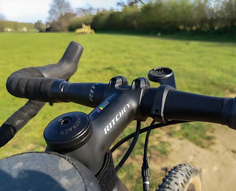 Ritchey WCS VentureMax bar and stem in close-up on a Bombtrack gravel bike, with a GPS mount beside the stem.