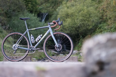 James Heaton's grey Trek Crockett 7 gravel bike with tan-wall WTB Byway tyres, parked by a waterfall in South Wales.