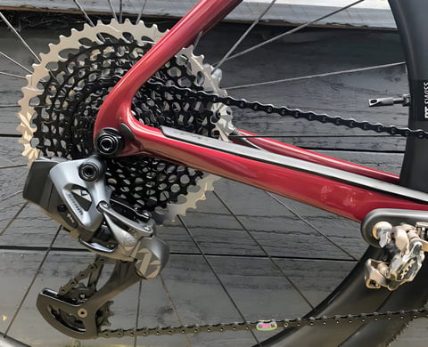 SRAM Eagle AXS rear derailleur and 10-50 cassette on a red Cervelo Aspero, the heart of a SRAM Mullet build.