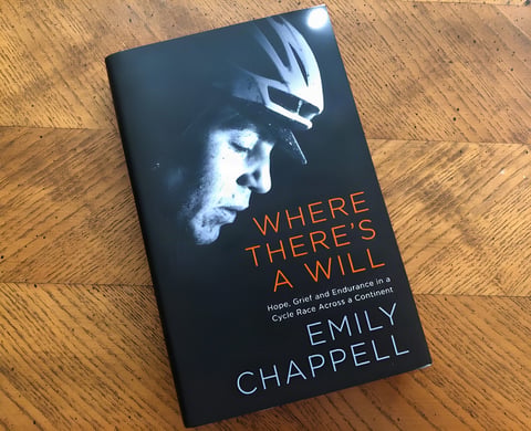 Hardback copy of Emily Chappell's Where There's a Will, her Transcontinental Race memoir, on a wooden table.