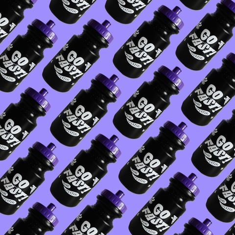 Rows of black Rune Creative Go Fast! water bottles with purple lids on a purple background.