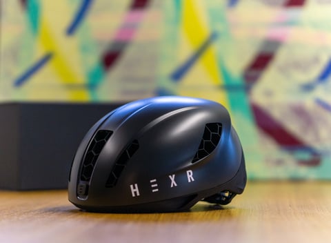 HEXR custom 3D-printed cycle helmet in matt black with white lettering and honeycomb-filled vents.