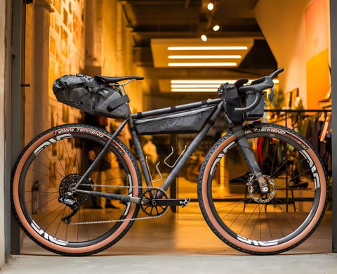 Belle Cycles A.T.E.R., a custom steel bikepacking bike built for the Atlas Mountain Race, in a shop doorway.