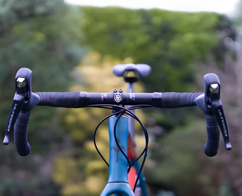 Ritchey WCS Butano handlebar fitted to a gravel bike, seen from the front with black tape and Ultegra levers.
