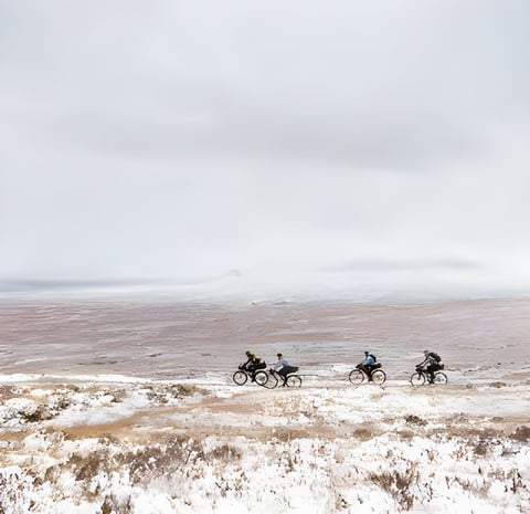 Four bikepackers ride a snowy moorland ridge in the Scottish Highlands in Pannier and Brother Cycles' film Rainspotting.