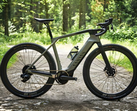 Canyon Grail:ON eGravel bike with Bosch motor, parked side-on on a forest gravel track.