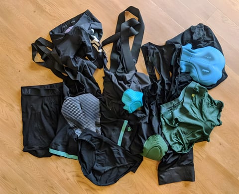 Pile of padded liner shorts, bib shorts and underwear in black and green, the options for wearing under baggies.