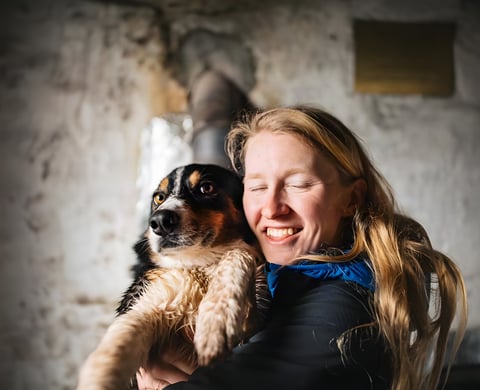 Pro MTB photographer Samantha Saskia Dugon laughs as she holds her dog Trigger, ahead of the AUTMNL ADVNTR challenge.