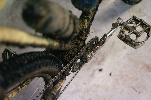 Close-up of a mud-clogged chain, chainring, pedal and frame on a bike back at Brother HQ in Faversham.