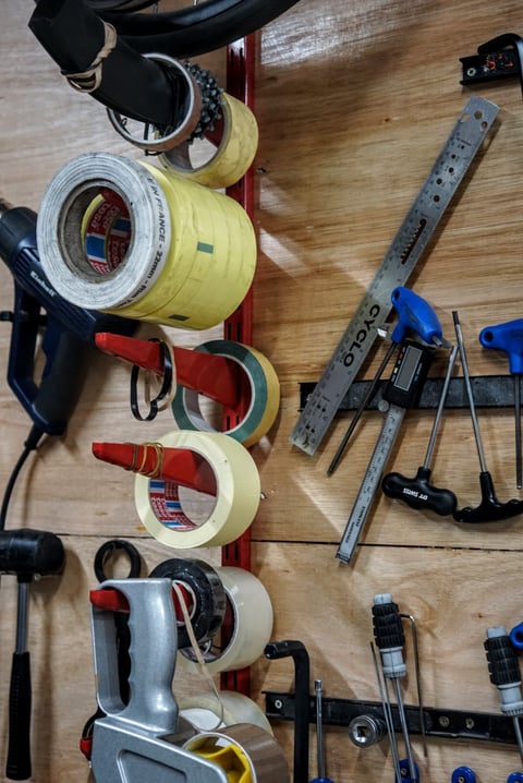 Rolls of masking tape, a steel rule and hex keys on the workshop wall at Stayer Cycles.