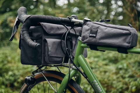 Gramm Tourpacking handlebar bag and top tube bag on the Woodland Green Fairlight Faran 2 in woodland.