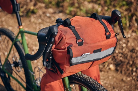 Rust-orange Road Runner Middle Earth handlebar bag on the Fairlight Faran, beside Shimano GRX brake levers.