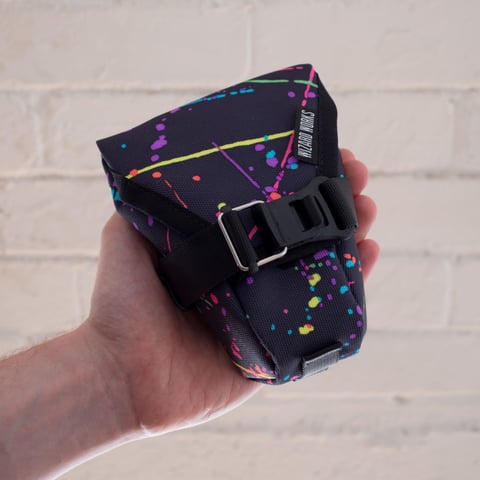 Medium Teeny Houdini in the neon splatter print, shown with the buckle fastened.