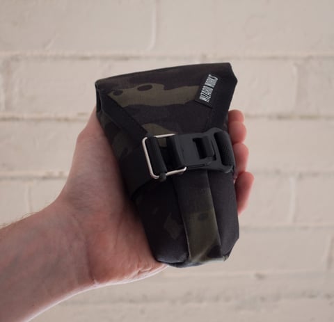 Small Teeny Houdini tool pouch in black camo fabric, held in a hand.