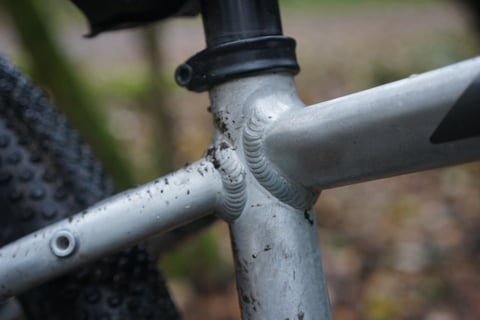 Detail of the welds where the seat tube, top tube and seat stays meet on the Riverside 920 alloy frame.