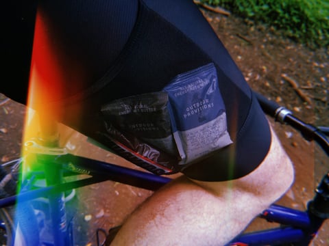 Santini Gravel Bib cargo shorts with energy nut butter sachets tucked in the mesh thigh pocket while riding.