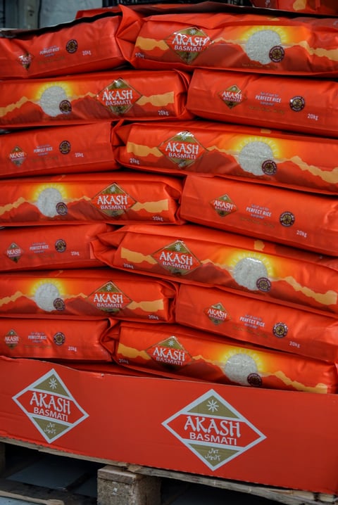 Stacked 20kg sacks of Akash basmati rice, a staple ingredient in Firepot Food meals, on a pallet.