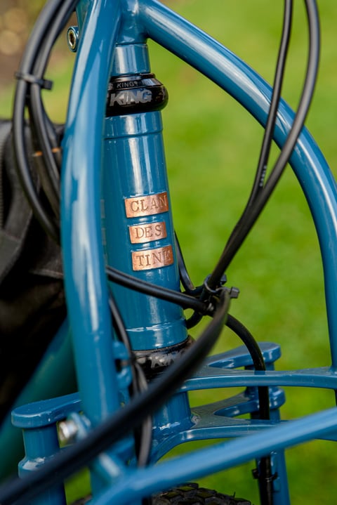 Copper Clandestine name plates on the blue head tube of the Long Tail, with a Chris King headset and the Truss fork.