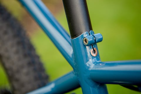 Seat cluster of the blue Clandestine Long Tail, with a cable guide and copper washer at the seatpost.