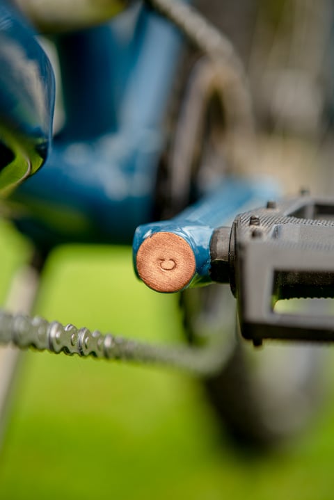 Copper-capped pedal boss on the Clandestine Long Tail's custom steel crank arm, with a flat pedal and chain.
