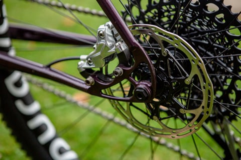 Slim rear dropout and disc brake mount on the Lord Cycles Nomad, with the calliper and rotor fitted.