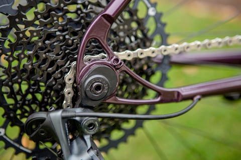 Close-up of the purple Lord Cycles Nomad rear dropout, cassette and chain, shown at Bespoked 2021.