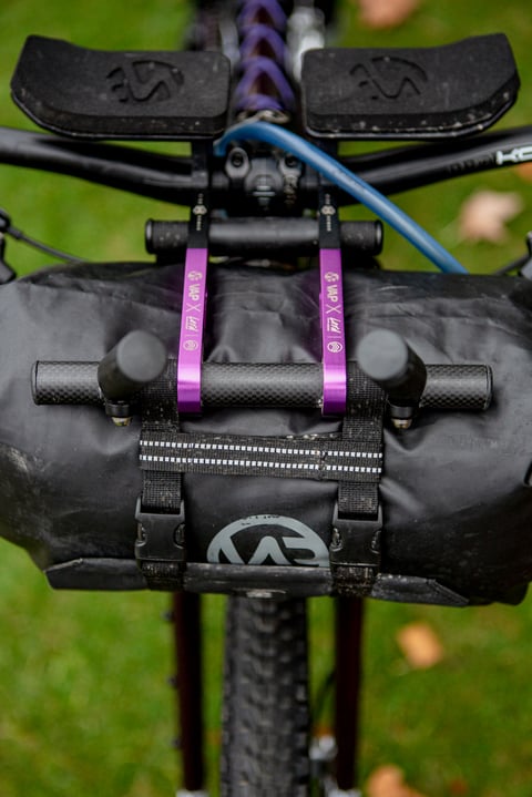 Front view of the Lord Cycles Nomad's handlebar bag and aero extensions, held by purple VAP x Lord straps.