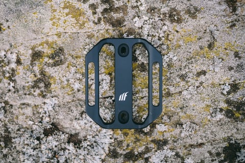 Black Tailfin Mini Cage seen from above, resting on lichen-covered rock.
