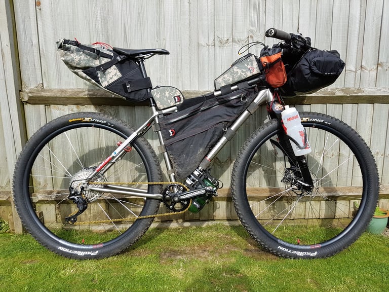 Author's Tour Divide bike, a titanium Charge Cooker with Continental X-King tyres and camouflage bikepacking bags.