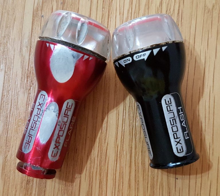Four-year-old Exposure Flare in red and Flash in black, with scuffs and worn flats on the alloy bodies.