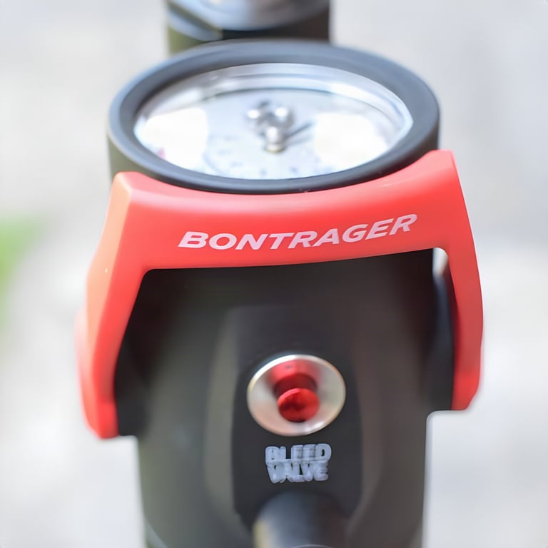 Close-up of the Bontrager Flash Charger pressure gauge, red lever and bleed valve button.