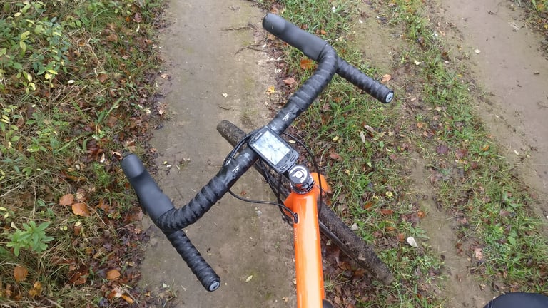 Orange Mason Bokeh test bike with Easton EC70 AX bars in black tape and a GPS computer on the stem.