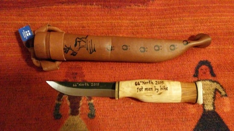 Rovaniemi 66 winner's trophy: a Finnish knife and leather sheath engraved "66° North 2015, 1st man by bike".