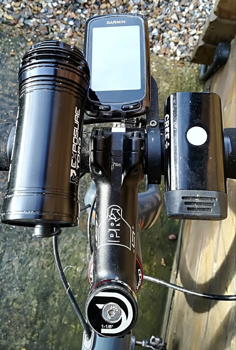 Cluttered handlebars with an Exposure Toro light, Garmin computer and a second light on separate mounts.